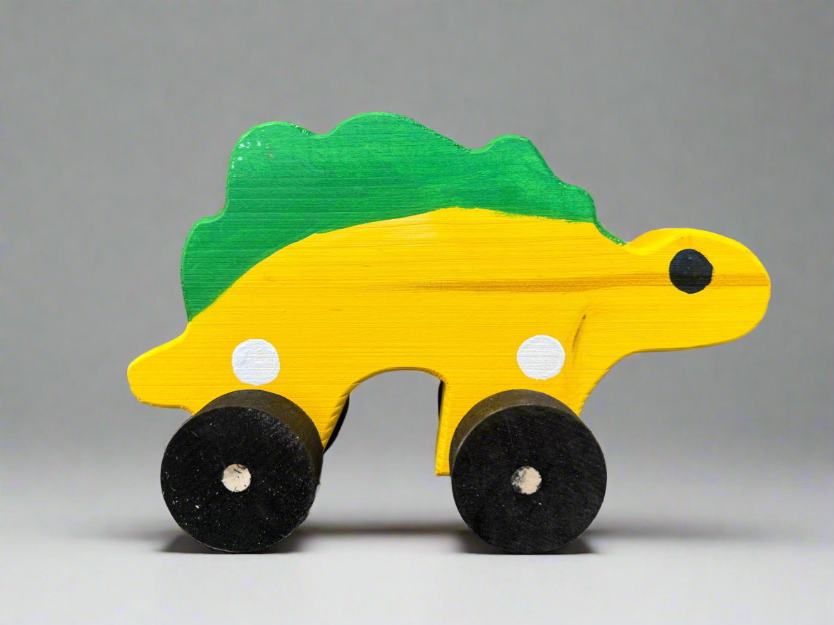 Handcrafted dinosaur kids pull toy in yellow and green with black wheels for toddlers