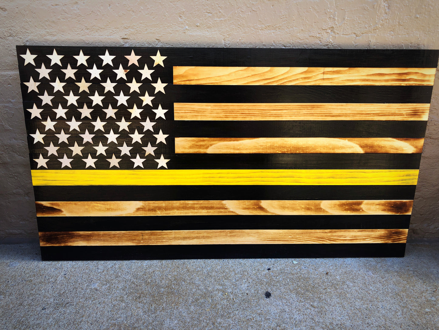 Thin yellow line wooden flag tow truck design with burned wood and black stripes for wall decor
