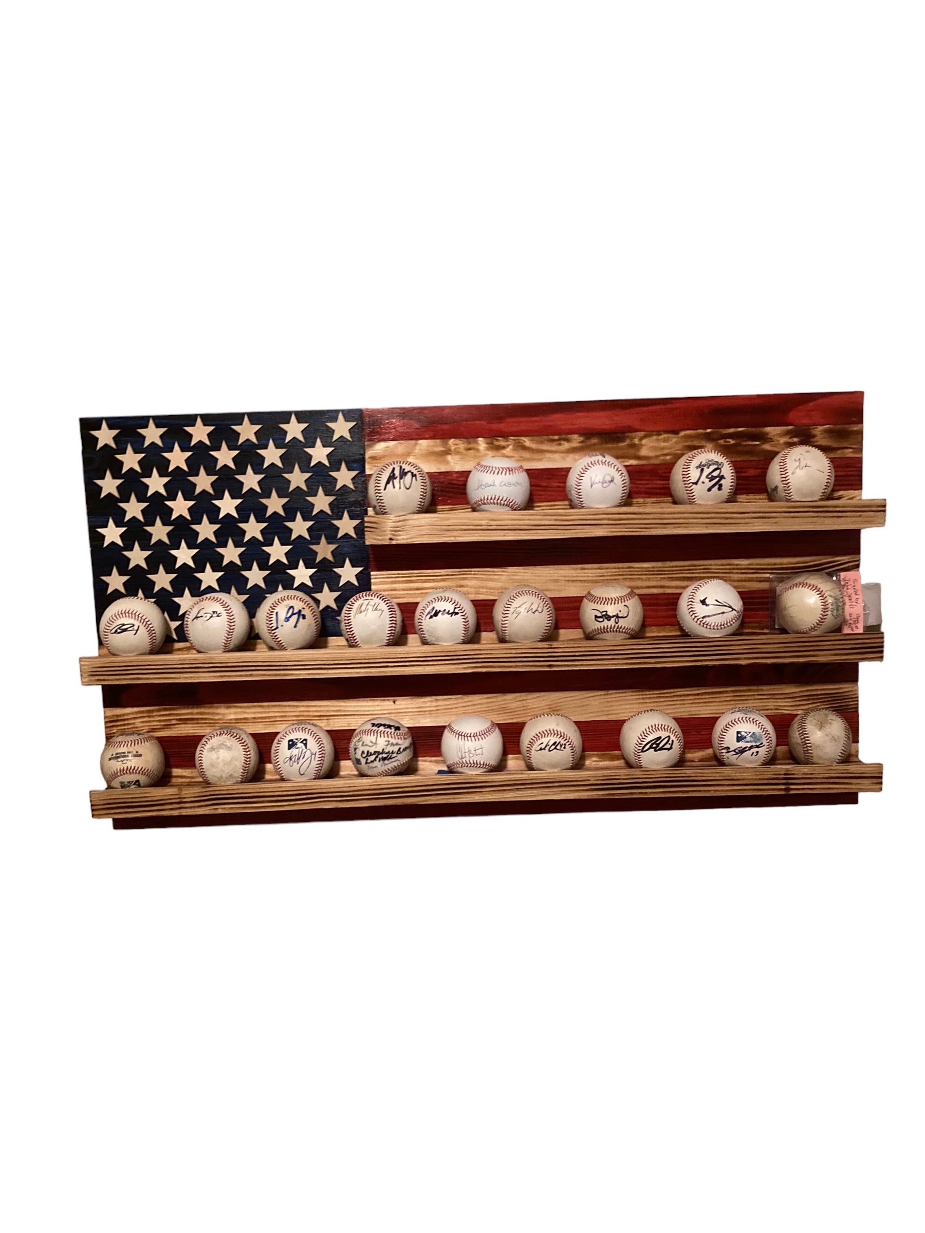 American flag baseball rack display holding multiple signed baseballs on wooden shelve