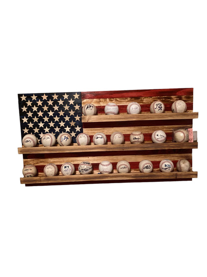 American flag baseball rack display holding multiple signed baseballs on wooden shelve
