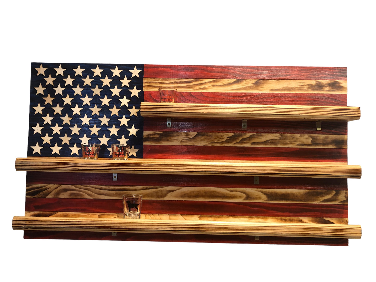 American flag shot glass holder display wall art made of rustic wood with three shelves holding shot glasses