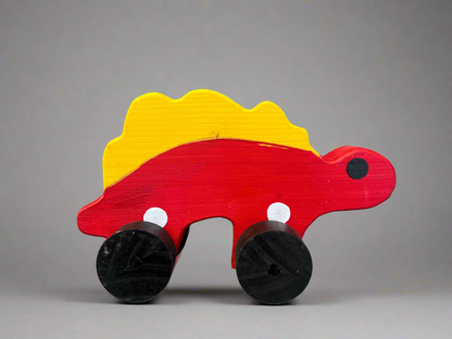 Handcrafted dinosaur kids pull toy in red and yellow wood with black wheels for toddlers