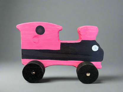 Handcrafted wooden train kids pull toy painted in pink and black with simple design and four wheels