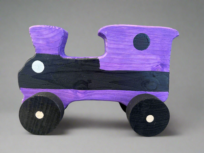Purple and black handcrafted wooden train kids pull toy with simple round wheels and painted details