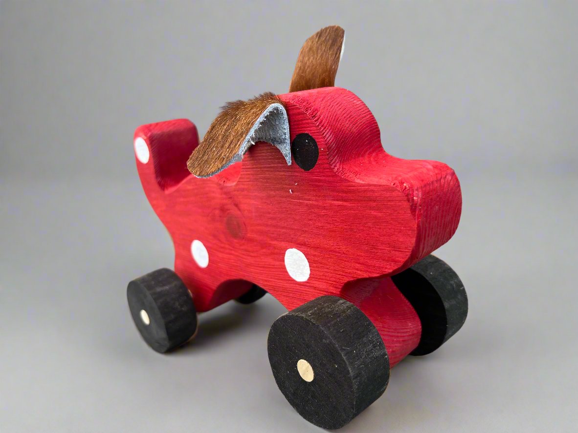 Handmade wooden dog pull kids toy in red with black wheels and fabric ears