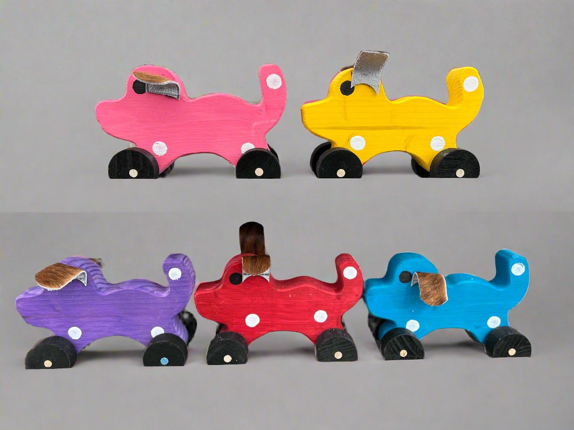 Colorful handmade wooden dog pull kids toy in pink yellow purple red and blue with black wheels