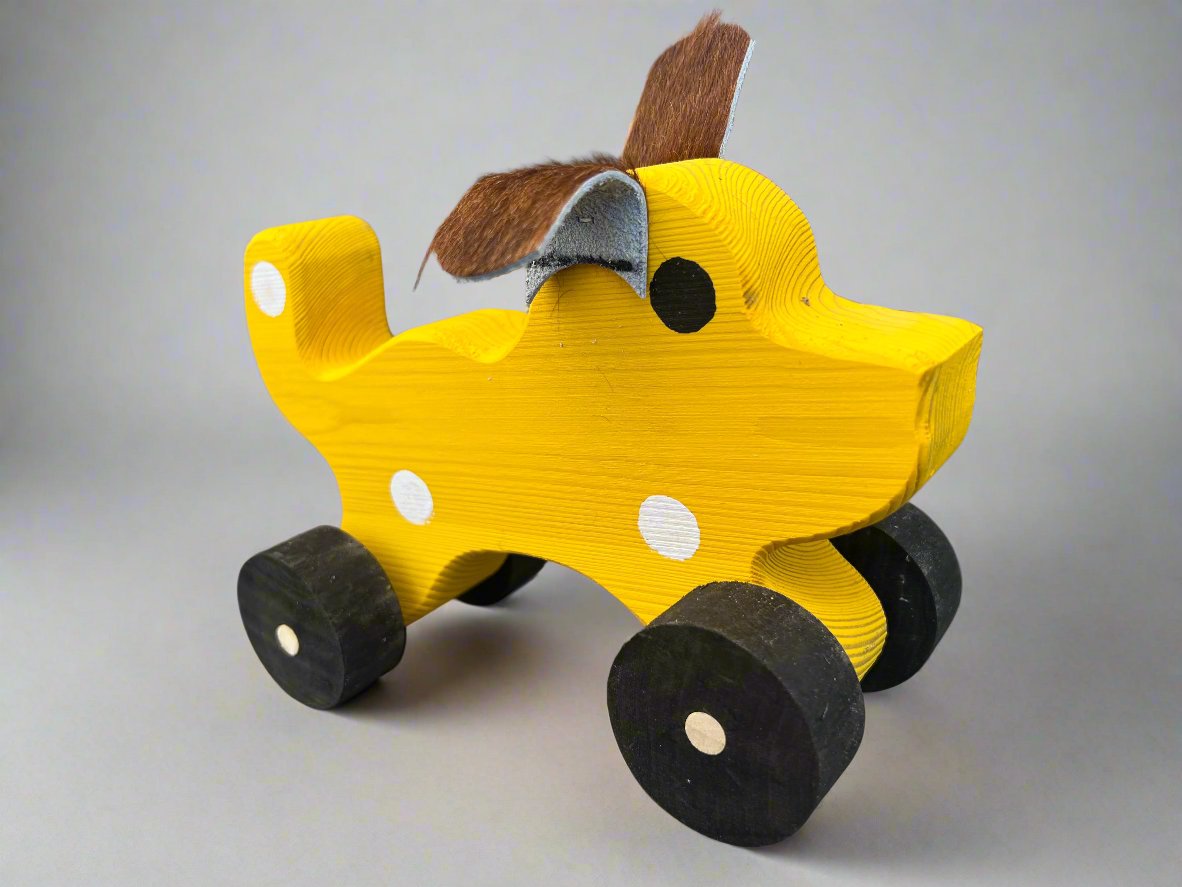 Handmade wooden dog pull kids toy in yellow with black wheels and felt ears