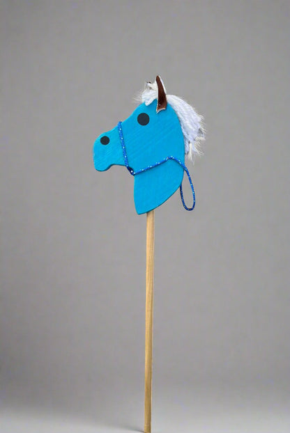 Blue kids wooden hobby horses with white mane and rope bridle on wooden stick