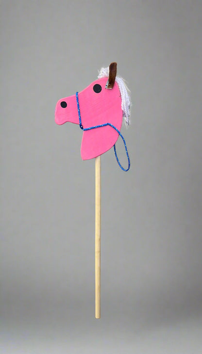 Pink kids wooden hobby horses with white yarn mane and blue rope bridle on wooden stick