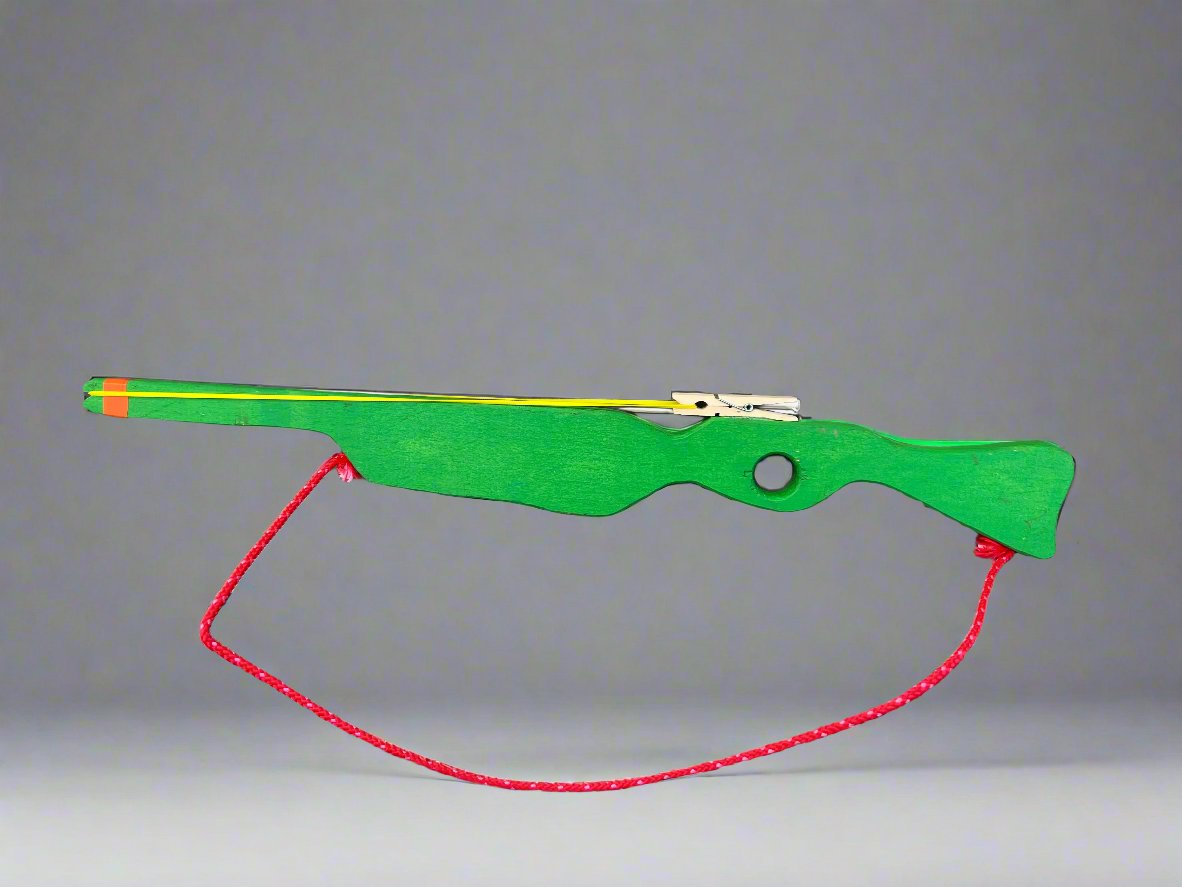 Green kids wooden rubber band launcher toy with red string and yellow rubber bands