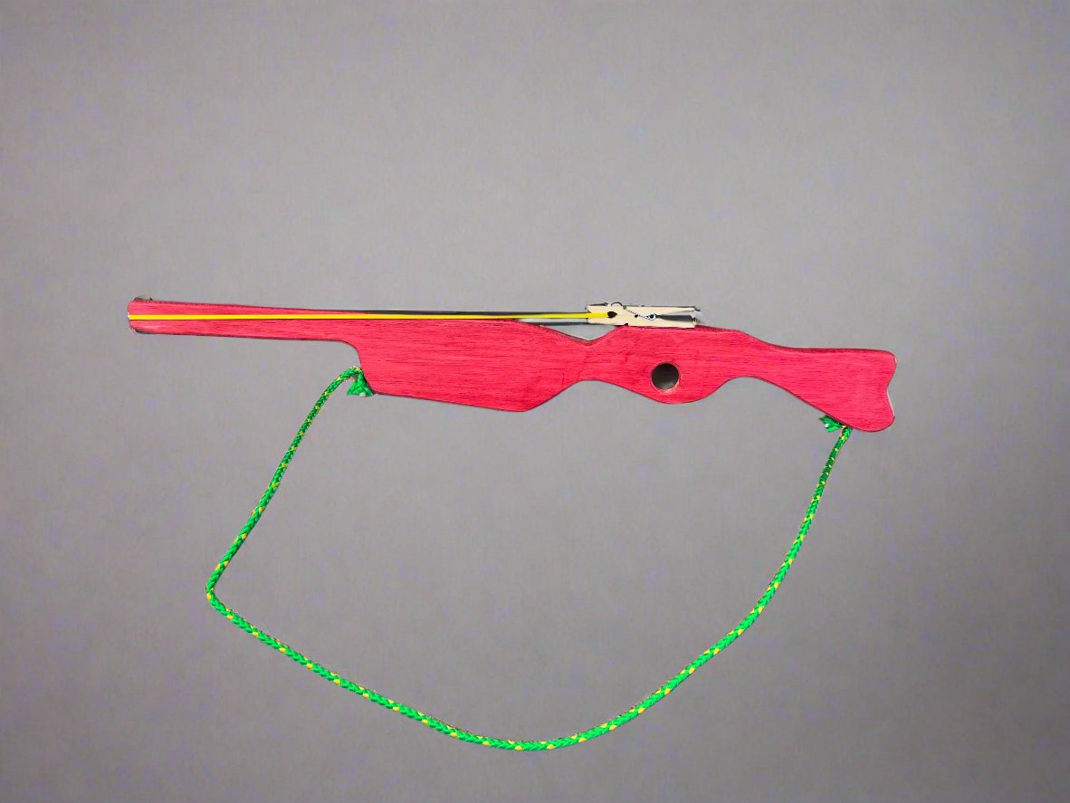 Red kids wooden rubber band launcher toy with green string for safe outdoor play