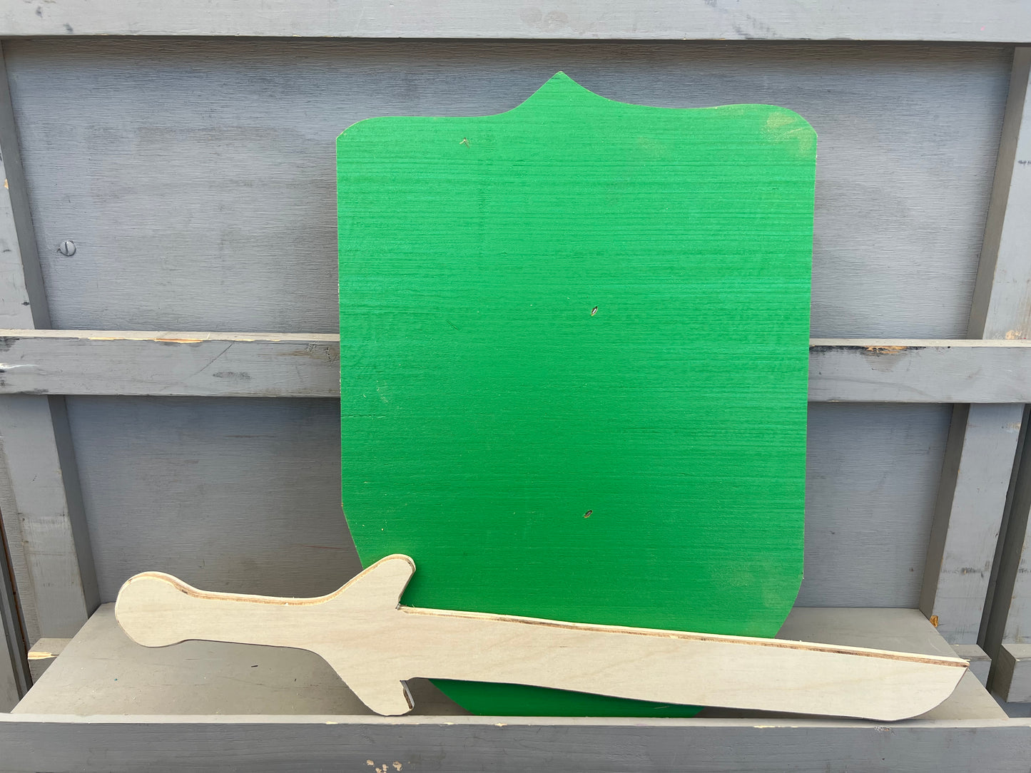 Kids wooden sword and shield set with a natural wood sword and a green painted shield for imaginative play
