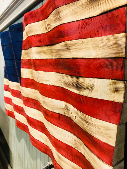 Rustic American flag wall art with distressed red white and blue wooden slats mounted on a wall