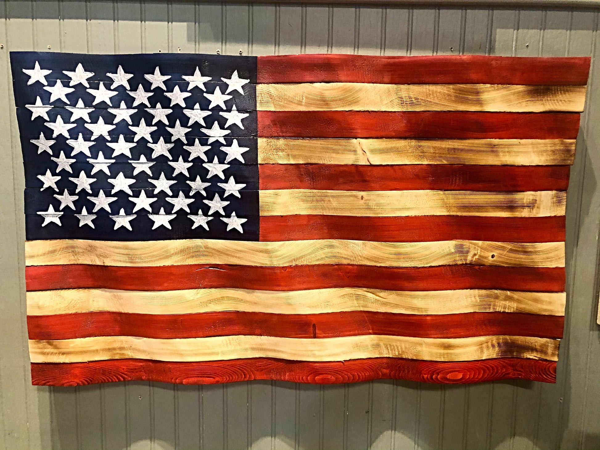 Rustic American flag wall art made of wooden planks with red, white, and blue colors