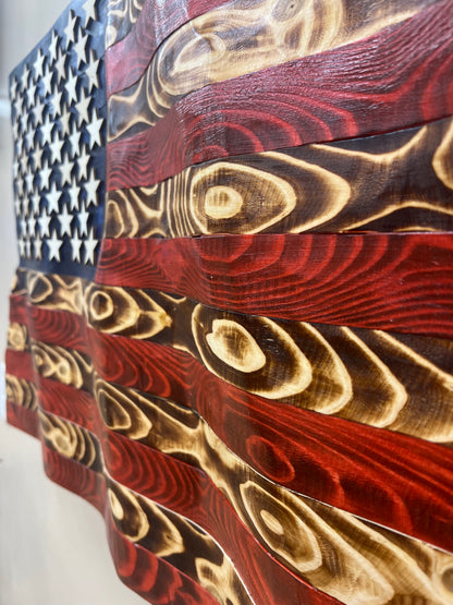 Rustic American flag wall art carved and painted on textured wood with burnt finish details