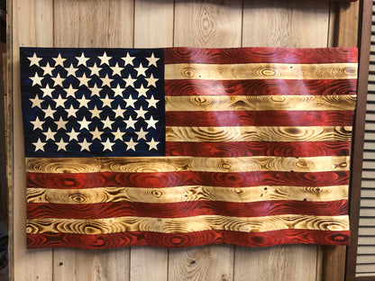 Rustic American flag wall art made of carved and stained wood with natural wood grain texture