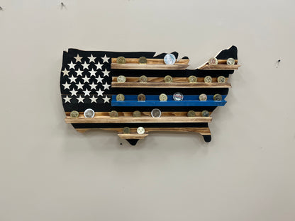 Thin blue line challenge coin holder wall art shaped like the United States flag with wooden shelves displaying challenge coins