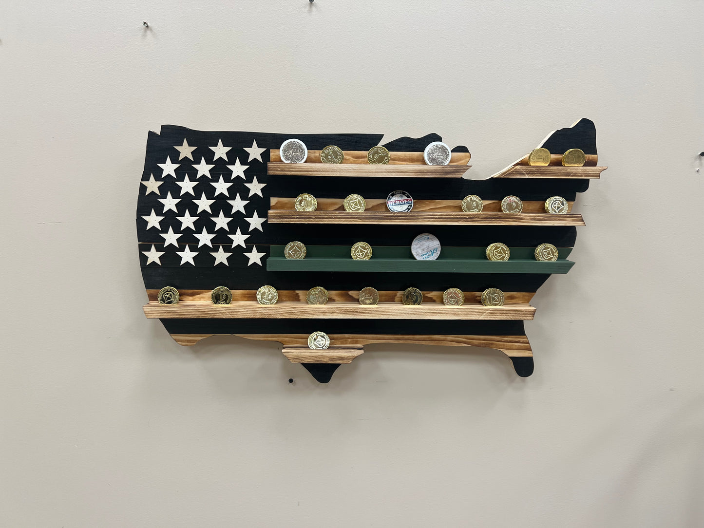 Thin green line wooden flag challenge coin holder shaped like the USA flag with multiple coins displayed