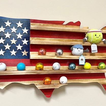 USA flag golfball display case shaped like the United States holding various golf balls and plush toys