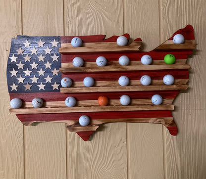 USA flag golfball display case shaped like the United States holding multiple golf balls on wooden background