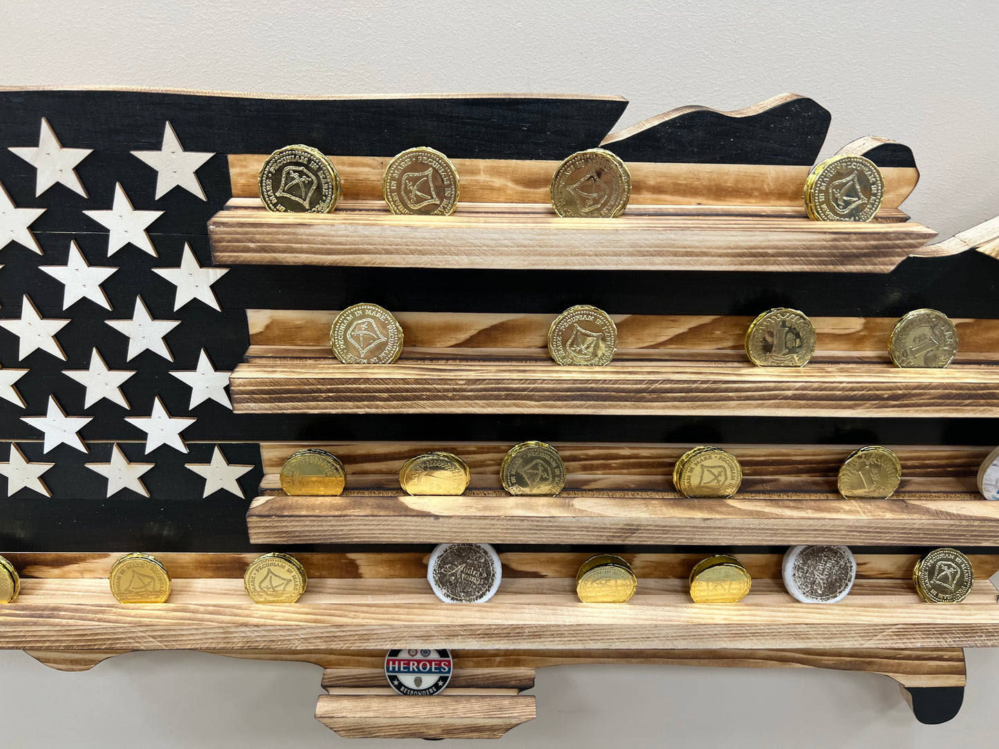 Wooden USA subdued challenge coin display flag with multiple military challenge coins on shelves