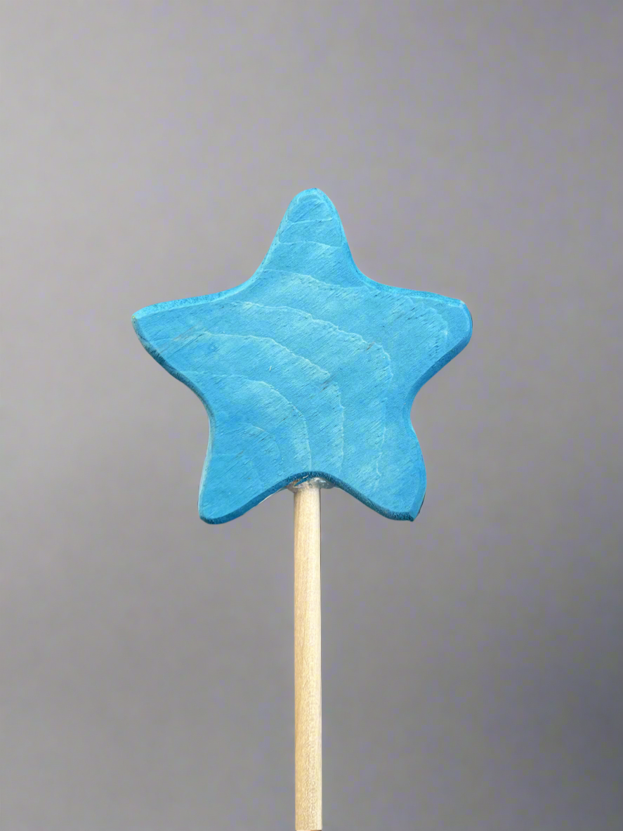 Blue star-shaped colorful wooden magic wand toy on a light wood handle for kids
