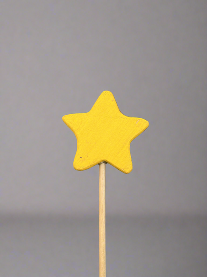 Colorful wooden magic wand toy with a yellow star on a natural wood stick for imaginative play