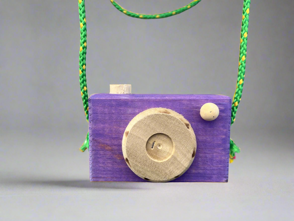 Handmade kids wooden camera in purple with natural wood lens and green strap for children