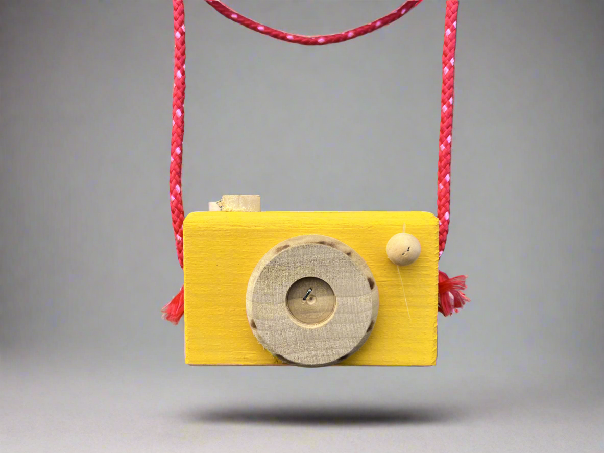 Handmade kids wooden camera painted yellow with red strap perfect for imaginative play