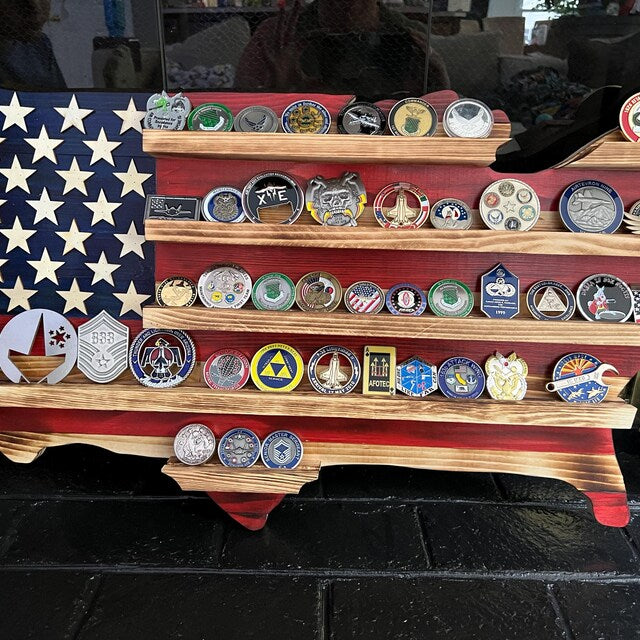 Wooden USA map coin holder displaying various collectible challenge coins on multiple shelves