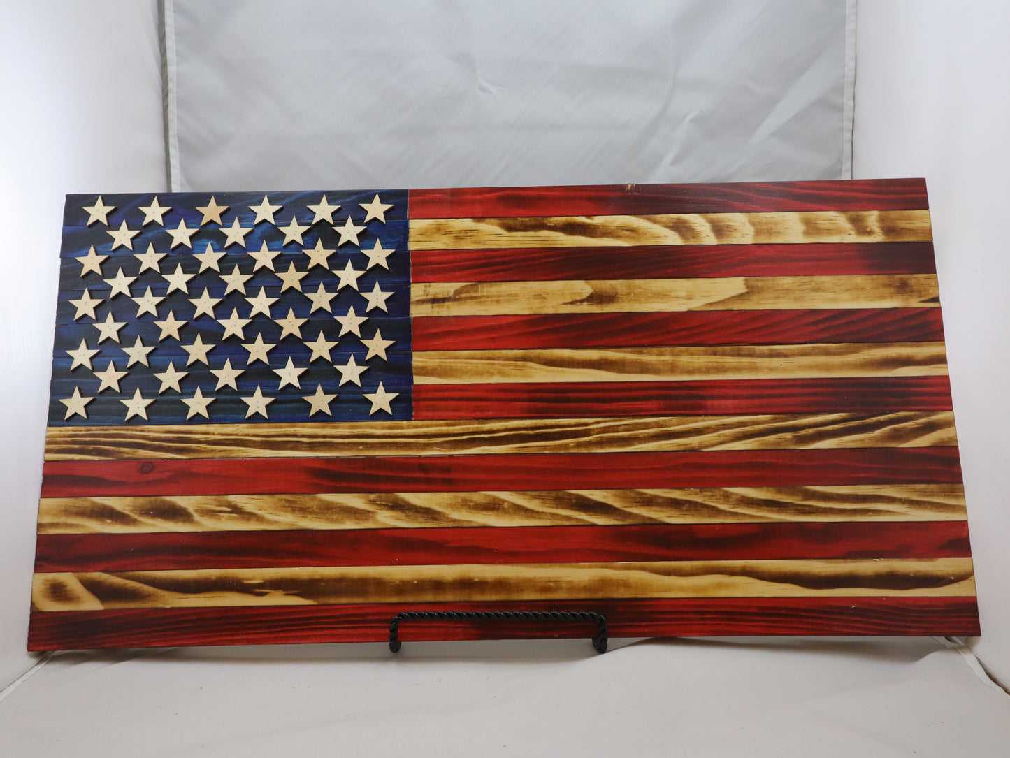 Handcrafted wooden American flag wall decor with natural wood grain and patriotic colors