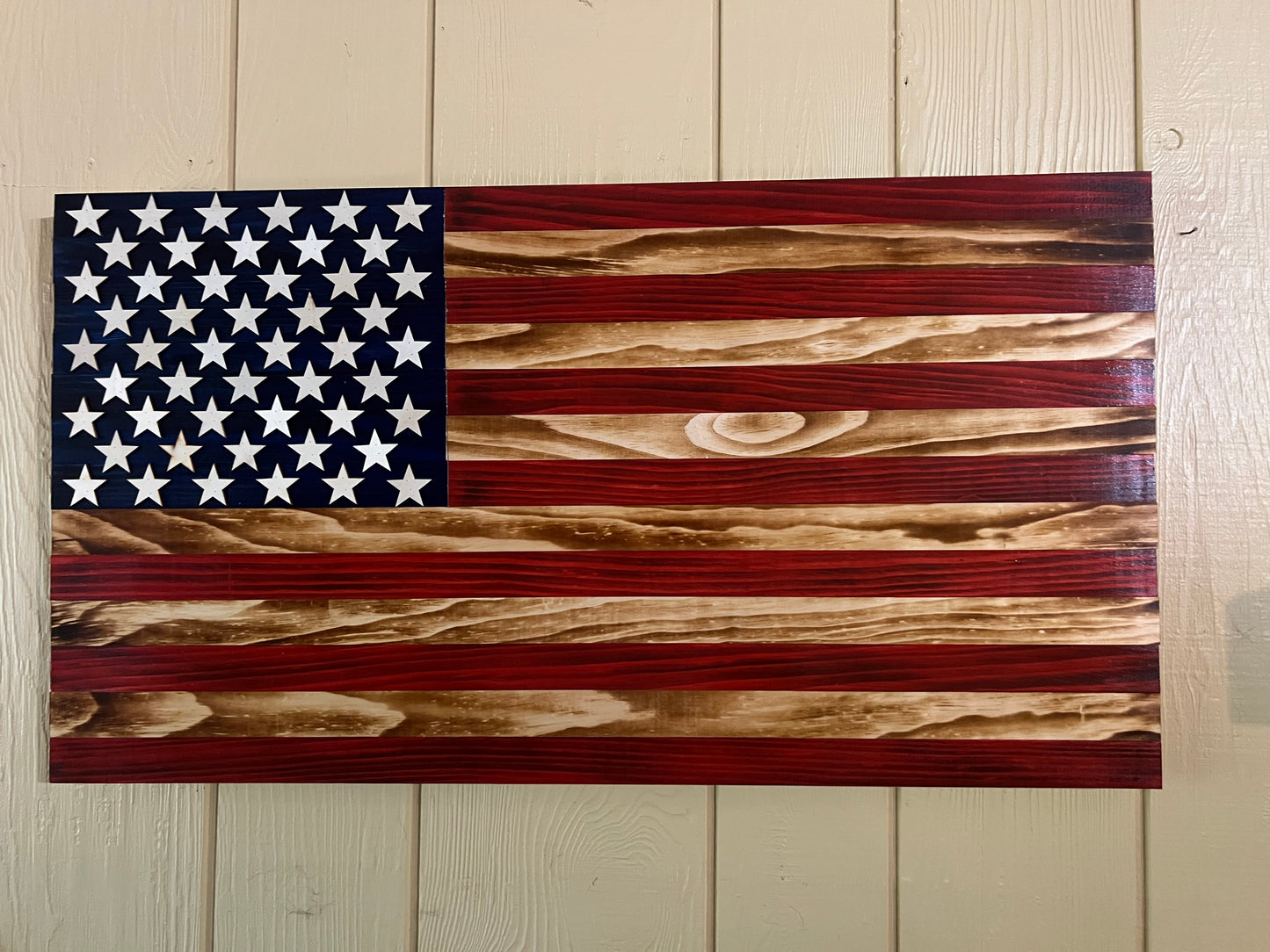 Handcrafted wooden American flag wall decor with rustic red and natural wood tones
