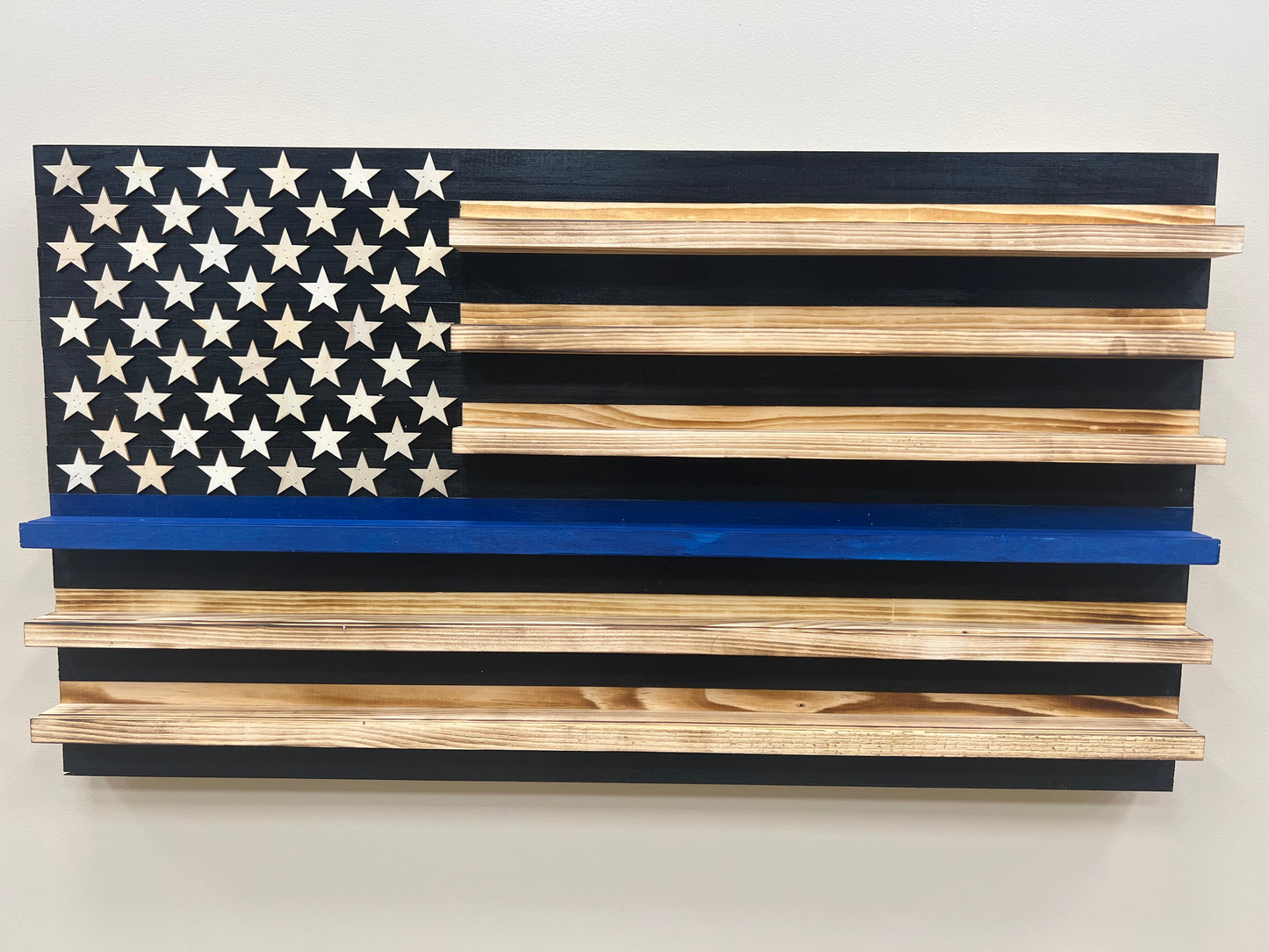 Wooden blue line flag coin holder display with natural wood shelves and black and white stars