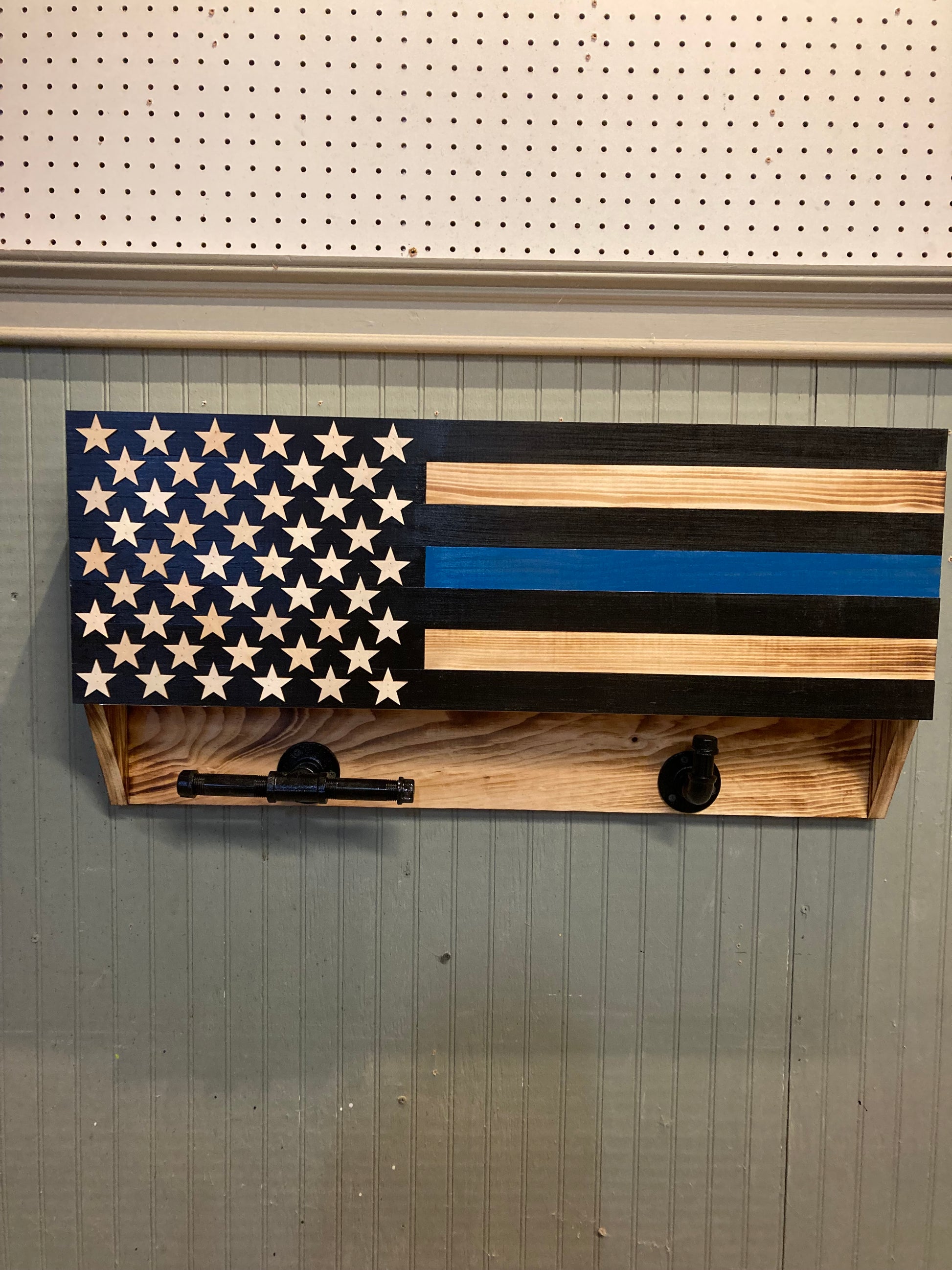 Wooden blue line front door box with American flag design and star cutouts mounted on wall