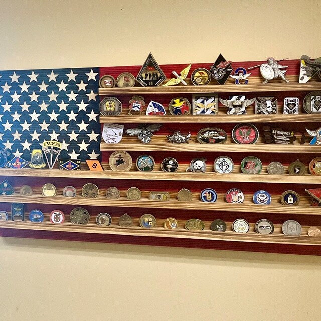 Wooden challenge coin holder flag wall art displaying various military challenge coins on American flag background