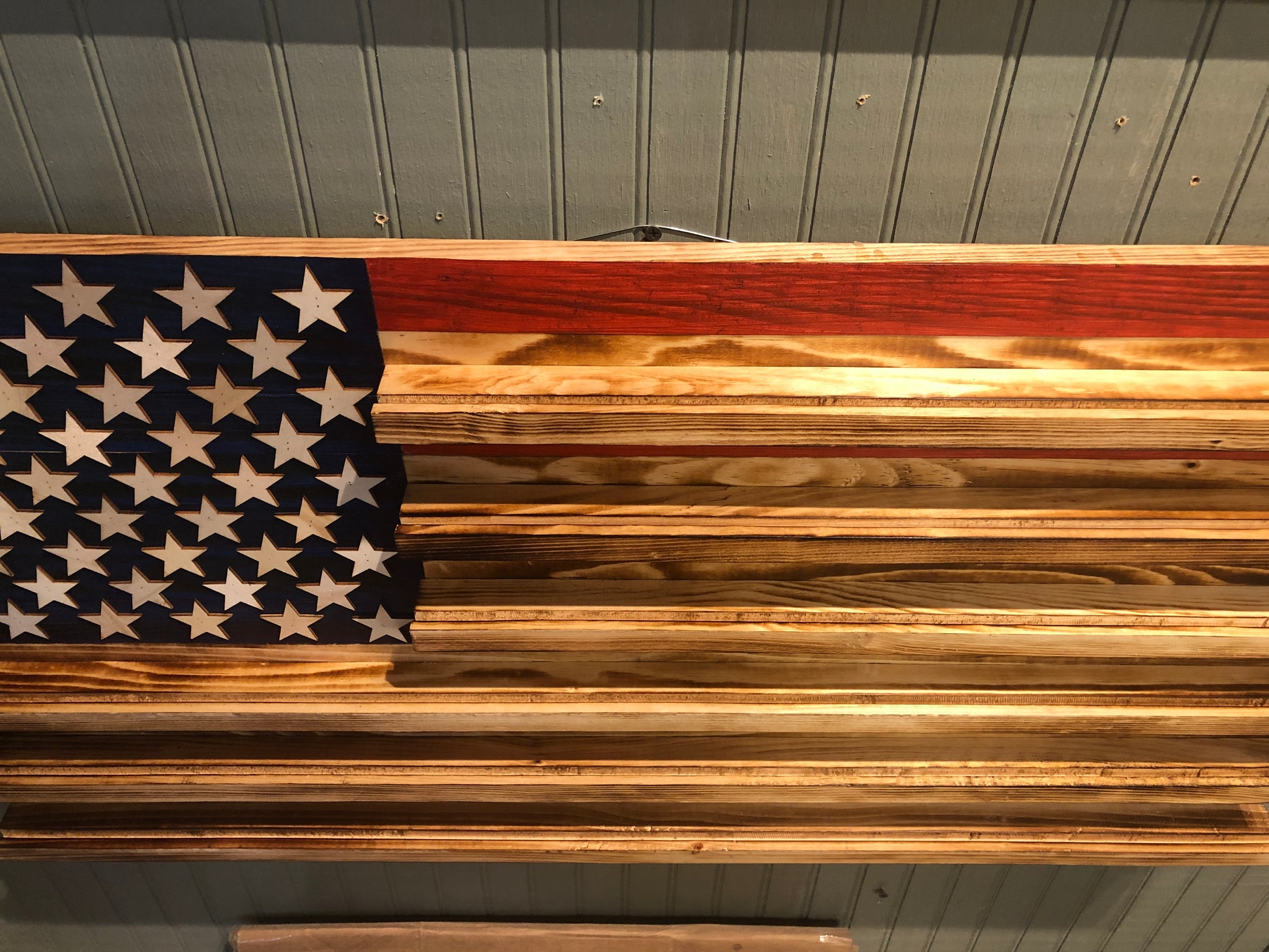 Wooden challenge coin holder flag wall art with American flag design and natural wood finish