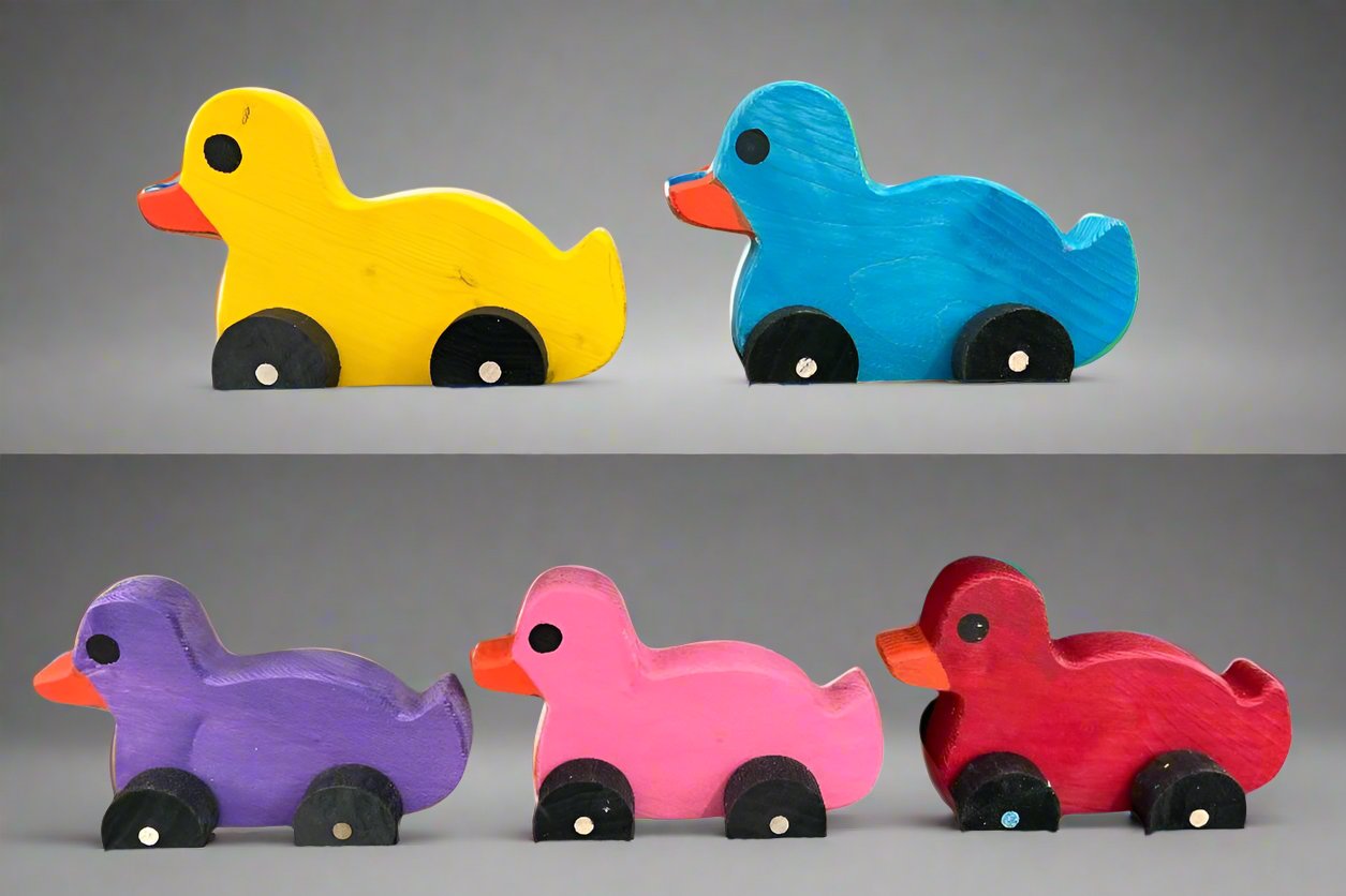 Colorful wooden pull duck toys in yellow blue purple pink and red with black wheels